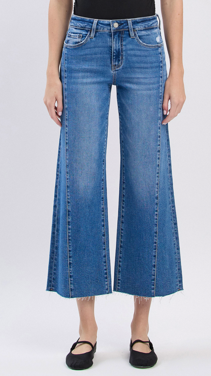 High Rise Medium Wash Raw Hem Twist Wide Leg Jeans