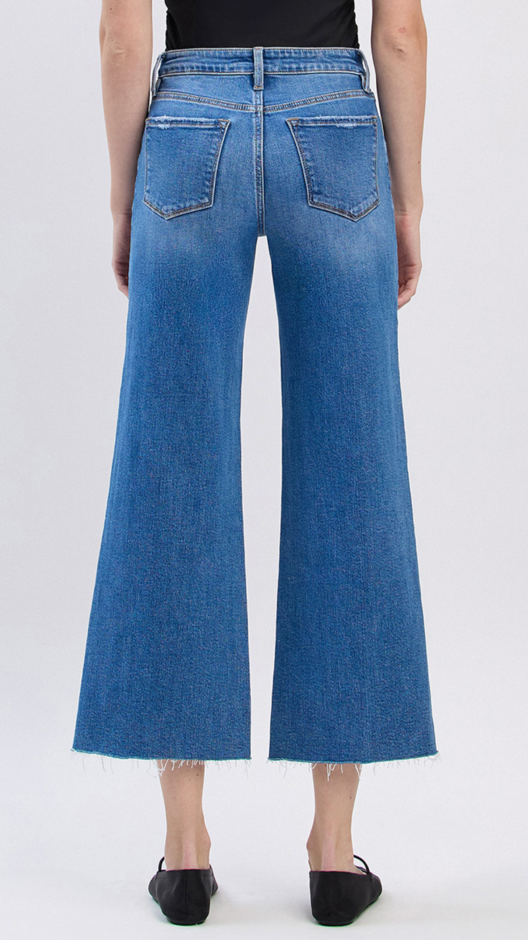High Rise Medium Wash Raw Hem Twist Wide Leg Jeans