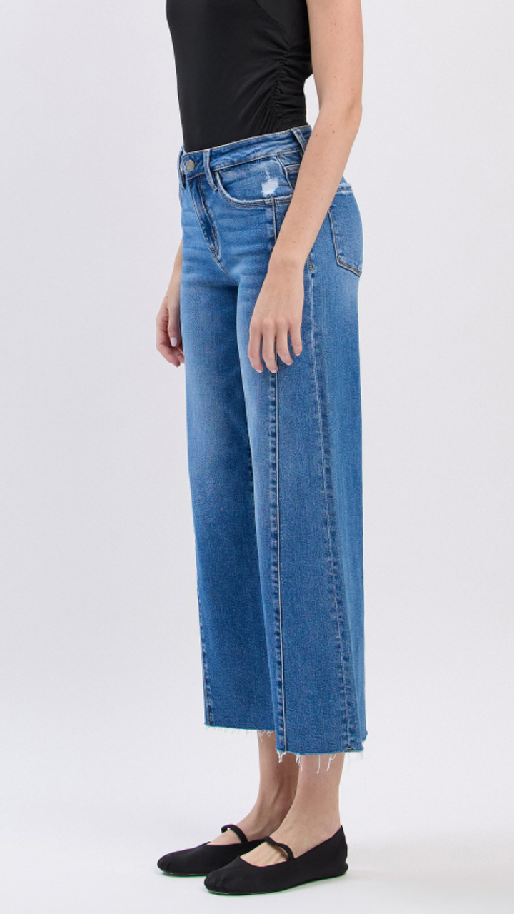 High Rise Medium Wash Raw Hem Twist Wide Leg Jeans